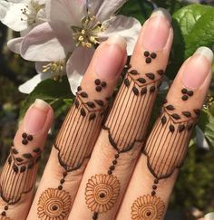 hendi designs on hands with flowers in the background