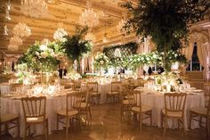 an elegant wedding reception with chandeliers and floral centerpieces