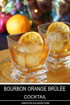 two glasses filled with lemonade sitting on top of a gold tray next to christmas decorations