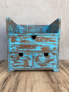 an old blue wooden drawer with three drawers