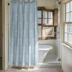 a bath room with a tub and a shower curtain