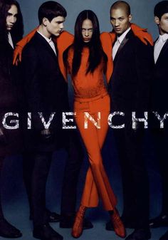 a group of people standing next to each other in front of a blue background with the words givenchy on it