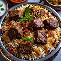 a close up of a plate of food with meat and rice