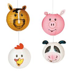 four paper lanterns with farm animals hanging from the ceiling, each decorated in different colors