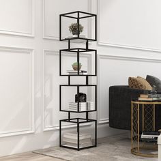 a black and white shelving unit in a living room next to a couch with a coffee table