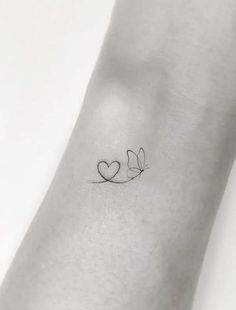 a small tattoo with two hearts on the wrist