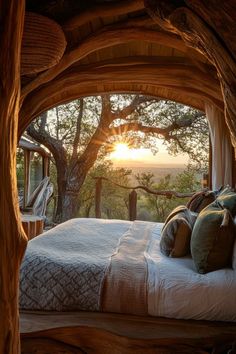 a bed sitting under a tree next to a window