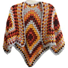 a crocheted cardigan is shown with an orange and yellow pattern on it