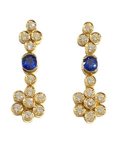 Expertly crafted 18k yellow gold Sapphire & Diamonds Dangle Earrings, 1 1/4 inch in length when worn on posts with secure wing backs. Each features an open bezel set with a fine oval blue sapphire measuring 4.8 x 4.1 mm, plus 12 bezel set 2.5 mm, 0.6 carat full cut diamonds of I color and VS clarity. An impressive 4.7dwt / 7.30 grams of gold. Diamond Dangle Earrings, Sapphire Diamond, Bezel Setting, Blue Sapphire, Diamond Cuts, 4 Inch, Dangle Earrings, Sapphire, Diamonds