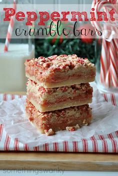 peppermint crumble bars stacked on top of each other with candy canes in the background