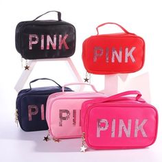 three pink and blue bags with the word pink written on them in silver letters, sitting next to each other