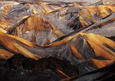 an aerial view of mountains and valleys in the desert