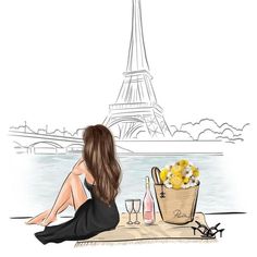 a woman sitting in front of the eiffel tower with her wine and flowers