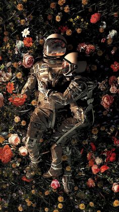 an astronaut sitting in the middle of flowers