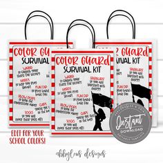 two red and white shopping bags with the words, color guard survival kit on them