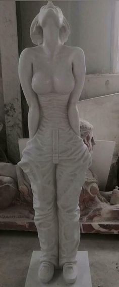 there is a white statue that looks like a woman with her hands on her hips