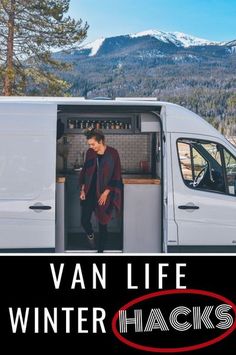 a man standing in the open door of a van