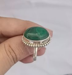 Add a touch of elegance to your outfit with this stunning handmade malachite oval gemstone statement ring. The ring features a beautiful green eye-clean gemstone that sparkles in the light. The adjustable band is made of 925 sterling silver and is bezel set with a 3mm wide band. This ring is perfect for any occasion, whether it's a special event like a wedding, graduation, or anniversary, or an everyday accessory. The vintage style and artful design make it a unique piece that will stand out in Oval Malachite Emerald Ring, Handmade Spiritual Oval Emerald Ring, Oval Emerald Ring With Natural Stones, Beautiful Green Eyes, Pretty Ring, Malachite Jewelry, Green Eye, Jewelry Beautiful, Ring Shapes