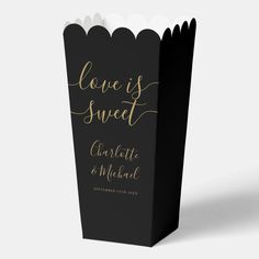 a black and gold wedding popcorn bag with the words love is sweet on it's side