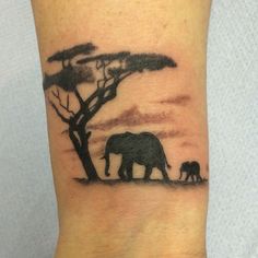 an elephant and her baby are silhouetted against the setting sun in this tattoo design