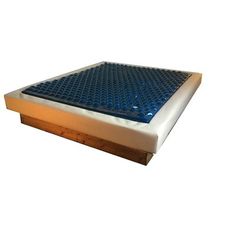 a close up of a mattress on a white surface with blue grate in the middle