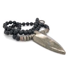 "This necklace was designed for the inner warrior with genuine Black Onyx and Pyrite 6mm beads. A large Pyrite arrow represents strength and power.  This really cool men's necklace is strung on the highest quality stainless steel beading wire for maximum strength and flexibility, then finished with a toggle clasp. Large Pyrite Arrows are approximately 2\" tall x 1 ⅞\" wide at the top. May your day be amazing, Saging Karma® 🦋 More Gemstone Necklaces https://www.etsy.com/shop/SagingKarma?ref=seller-platform-mcnav&section_id=27598570 Return to Saging Karma® shop: https://www.etsy.com/shop/SagingKarma?ref=seller-platform-mcnav Invoices will be included upon request. ✍︎  Orders totaling over $249.00 are shipped with signature required for delivery. © 2023 Saging Karma® Portland, Oregon.  All p Spiritual Hematite Jewelry With Polished Beads, Spiritual Silver Obsidian Necklace, Artisan Black Necklace With Oxidized Finish, Black Warrior Style Jewelry As Gift, Black Warrior Style Jewelry For Gift, Black Hand Forged Spiritual Necklace, Black Hand-strung Amulet Jewelry, Karma Jewelry, Warrior Necklace