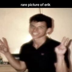 a man is smiling and holding his hands up in front of him with the words rare picture of eric on it