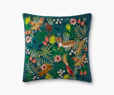 a green pillow with tiger and flowers on it