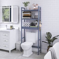 a bathroom with a toilet, sink and shelving unit next to a bathtub