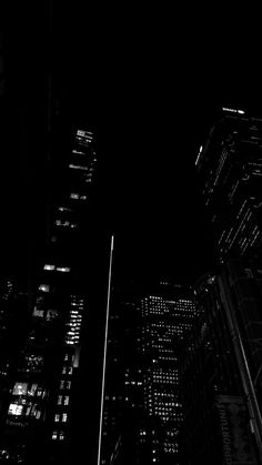 black and white photograph of skyscrapers at night