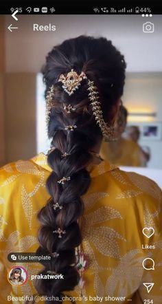 an image of a woman with long hair in braids and gold jewelry on her head