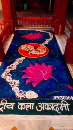 there is a blue rug with pink flowers on it