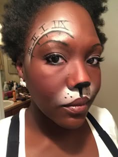 a woman with her face painted to look like a cat and the words hello kitty written on her nose