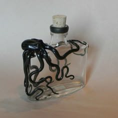 a glass bottle that has some kind of black thing in it