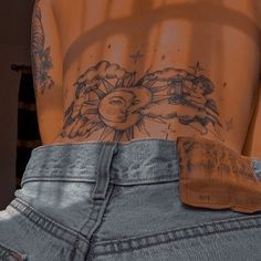 the back of a person's stomach with tattoos on it