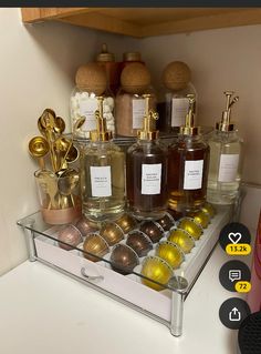 a shelf filled with lots of different types of perfumes on top of a counter