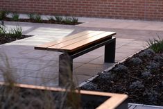 a wooden bench sitting on top of a sidewalk