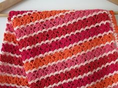 two pieces of crocheted blanket sitting on top of each other