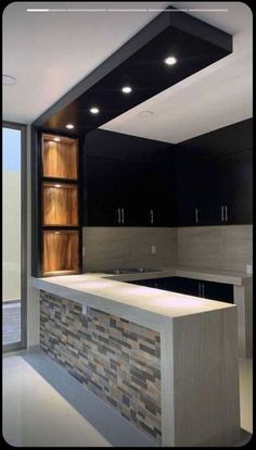 an empty kitchen with black cabinets and white counter tops is seen in this image from the inside