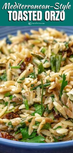 a blue plate topped with pasta and greens