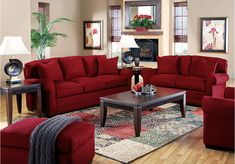 a living room filled with red couches and chairs