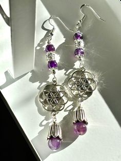 Amethyst Seed of Life/Flower of Life Silver Mandala Dangle Earrings Materials ~  925 Sterling Silver Ear Hooks  Silver plate (lead & nickel free) Natural Amethyst Gemstone Beads Appropriate length ~ 10cm  Also available in ~ Malachite (green), Jasper (brown), Garnet (deep red), Hematite (gold). Silver Spiritual Crystal Earrings Nickel Free, Silver Amethyst Crystal Earrings With Ear Wire, Silver Nickel-free Spiritual Crystal Earrings, Nickel-free Amethyst Earrings For Healing, Nickel-free Silver Crystal Earrings For Spiritual Use, Nickel-free Silver Amethyst Crystal Earrings, Nickel-free Purple Crystal Earrings In Sterling Silver, Silver Amethyst Crystal Earrings, Silver Amethyst Crystal Earrings For Pierced Ears