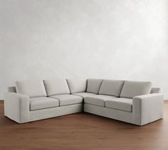 a white couch sitting on top of a wooden floor