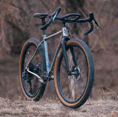 a bike parked on top of a dry grass field