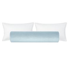 two pillows and a pillow case on top of each other, one is light blue