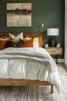 a bedroom with green walls, white bedding and wooden headboard in the middle