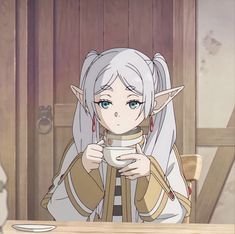 an anime character sitting at a table holding a cup