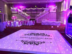 the dance floor is decorated with pink and white lights for a birthday party or special occasion