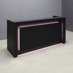 a black counter with purple lights on the top and bottom shelf, in front of a gray wall