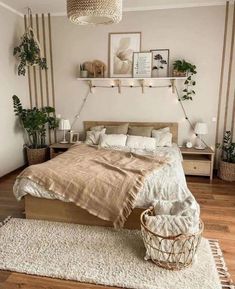 a bedroom with a bed, nightstands and potted plants on the wall above it